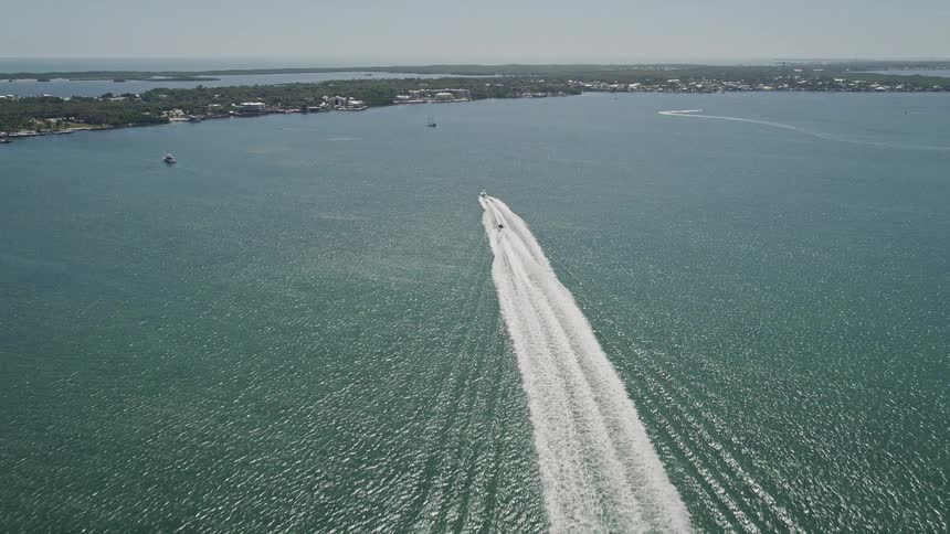 Two racing boats approaching the shore as seen from an aerial over Blackwater Sound Key Largo Florida during the daytime