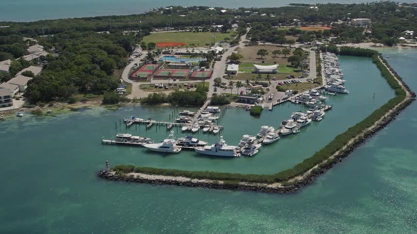 Flying over docked fishing boats at Plantation Yacht Harbor Resort in Islamorada Florida during a sunny day