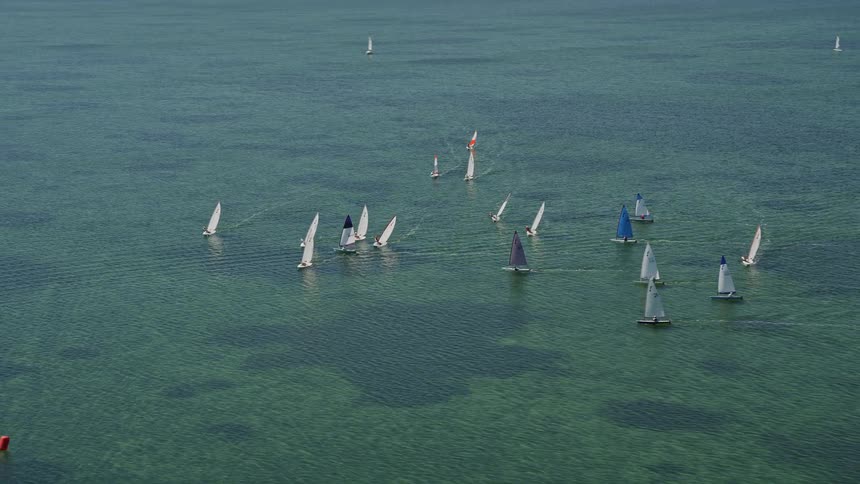 Sailboats sail close together in the sea off Buttonwood Sound Key Largo Florida during summer