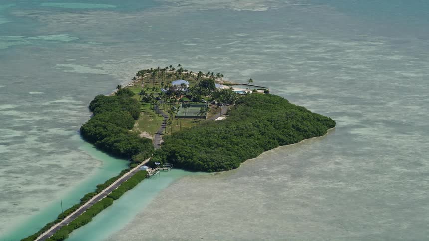 Aerial footage of a large residential property on a small island in Islamorada Florida during the daytime