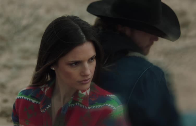 Close up of the faces of a man and a woman standing back to back outdoors