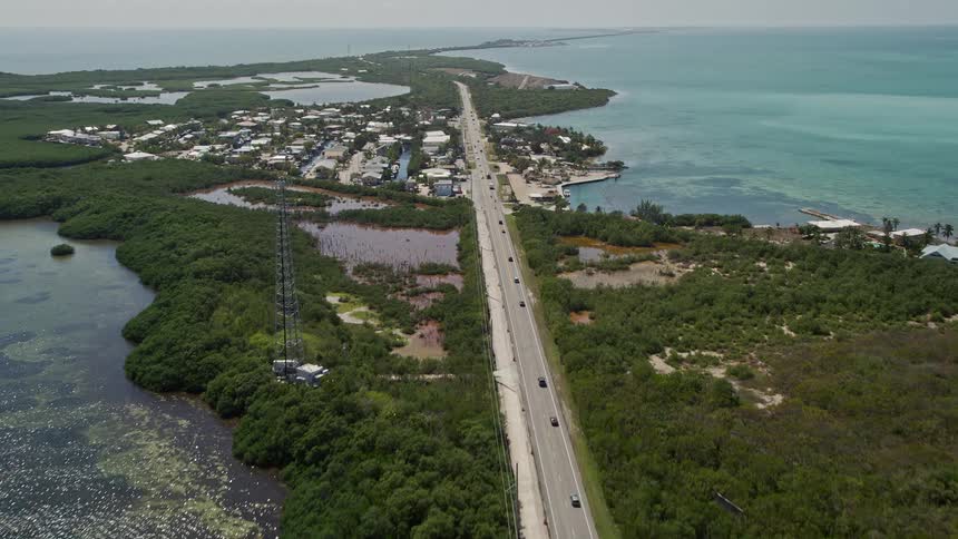 Aerial view of Overseas Highway pans over Layton Florida showcasing coastal neighborhoods and roads