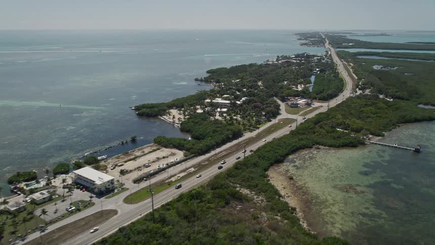 Aerial view of traffic passing by resorts and marinas along the Overseas Highway in Islamorada Florida