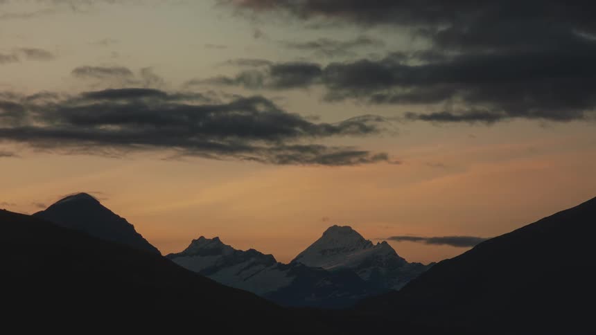Aerial view of the sun setting above the mountains