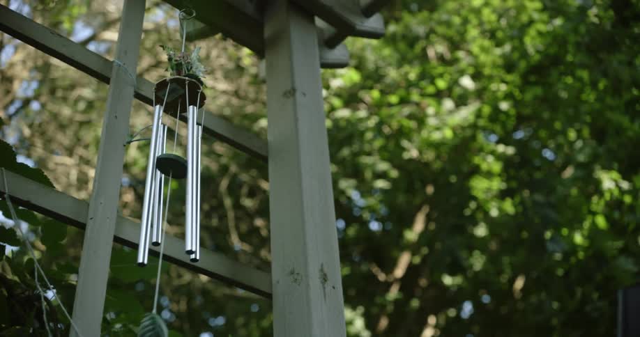 Wind chimes waving in wind in the garden