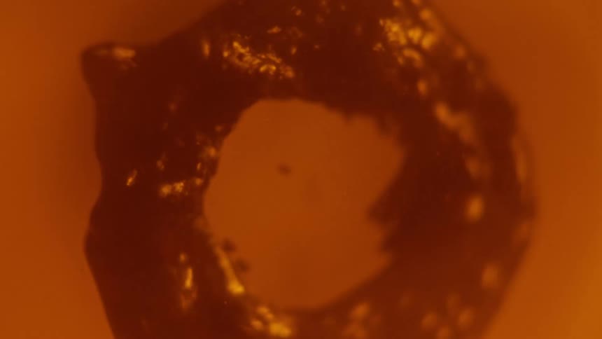 Dark fluid moving around in a blob in liquid around it
