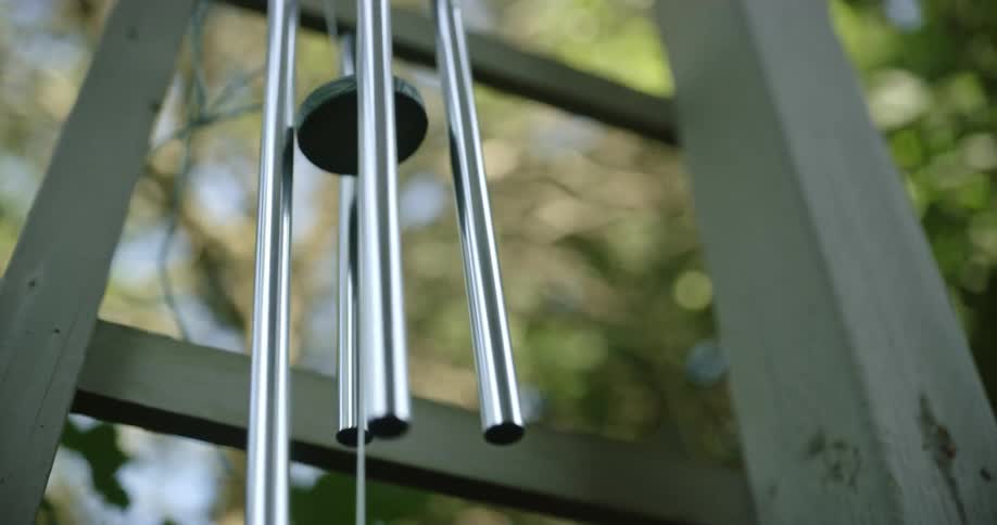 The wind blows vigorously and a set of wind chimes sway around
