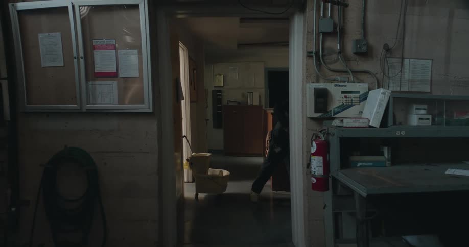 A man is mopping a room at his place of employment