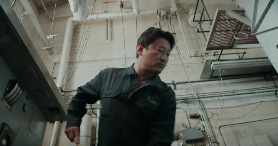 A man is mopping the floors in a building
