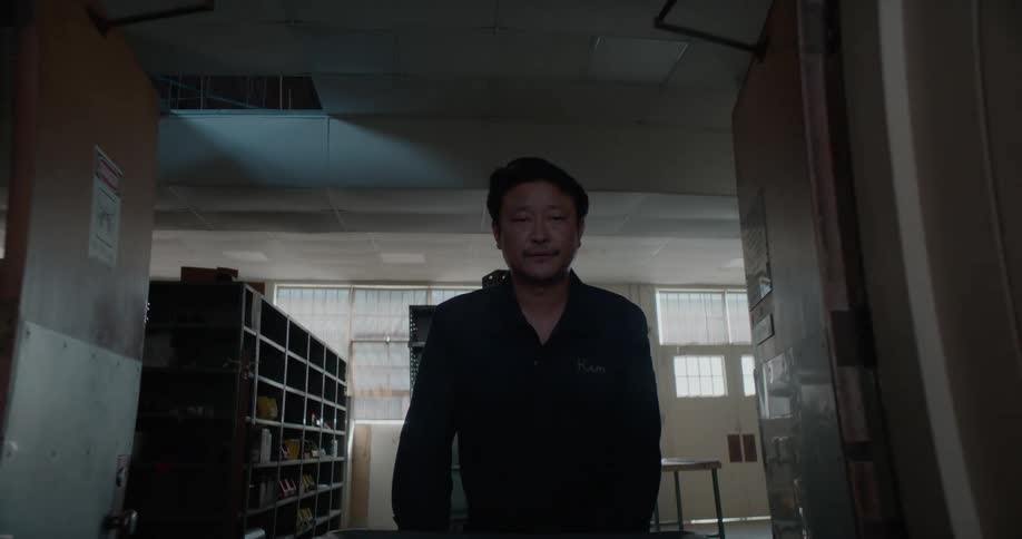 Janitor pushes cart through hallways in a building during the day