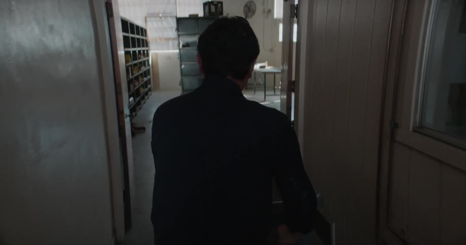A man wheels a large basket into a room at a hotel