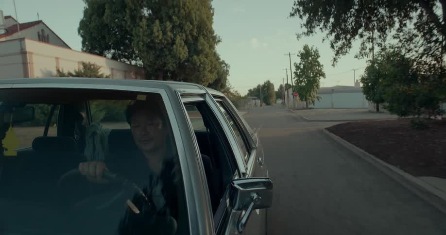 Man drives a car with an air freshener hanging from the rear view mirror