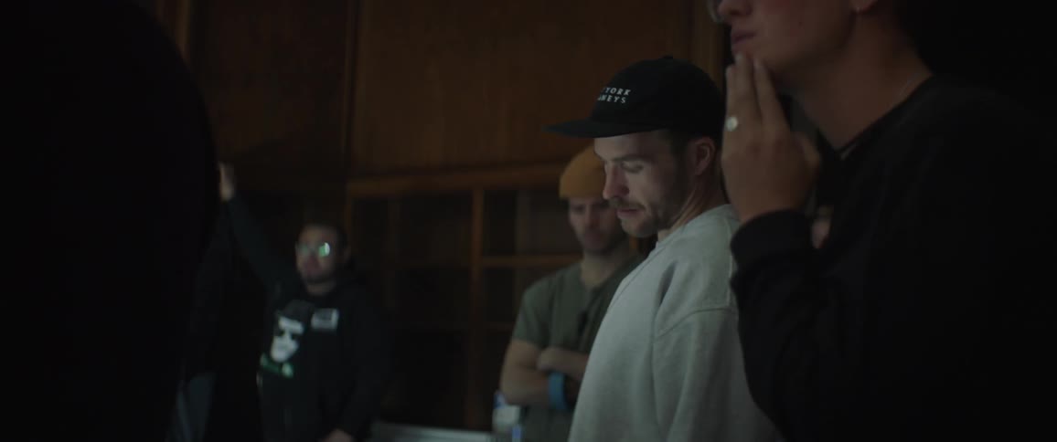 The people stand together in the room working