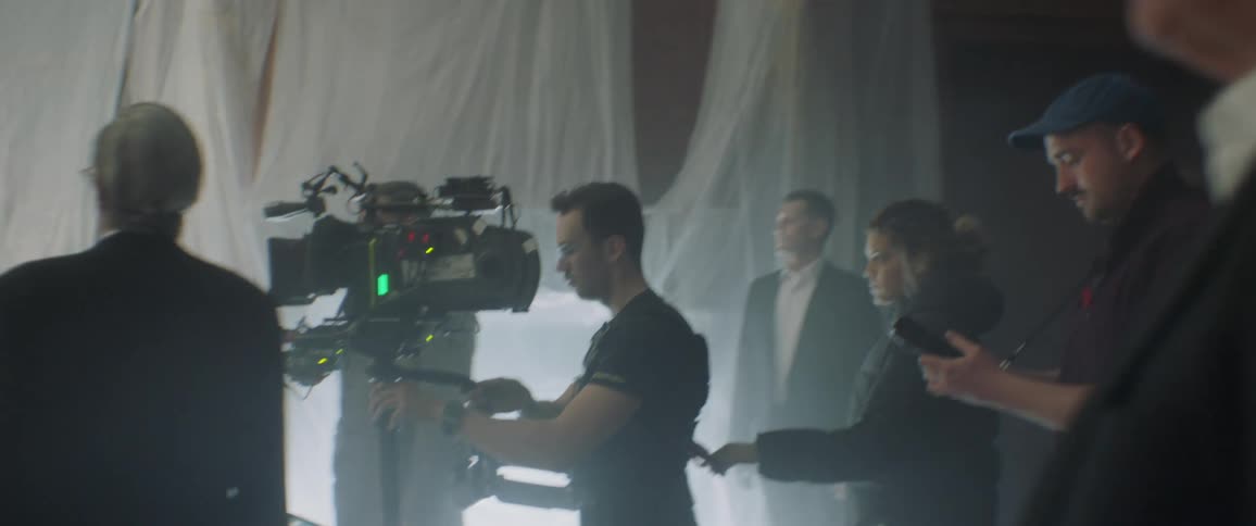 The people are filming a scene in the dark room