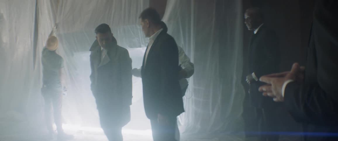 People stand together talking on a film set