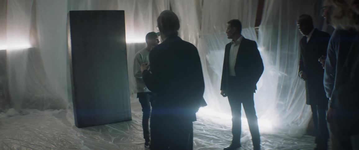 A group of people talk standing on plastic sheets