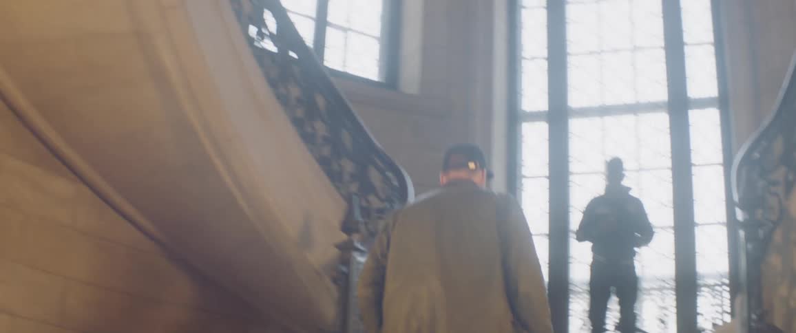 A group of people walk down the hallway