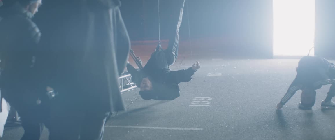 Man hangs from the wires as he is being video recorded