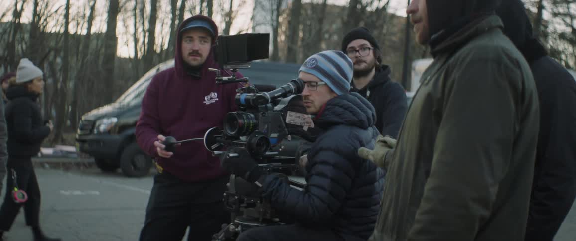 Film crew recording outside in the evening