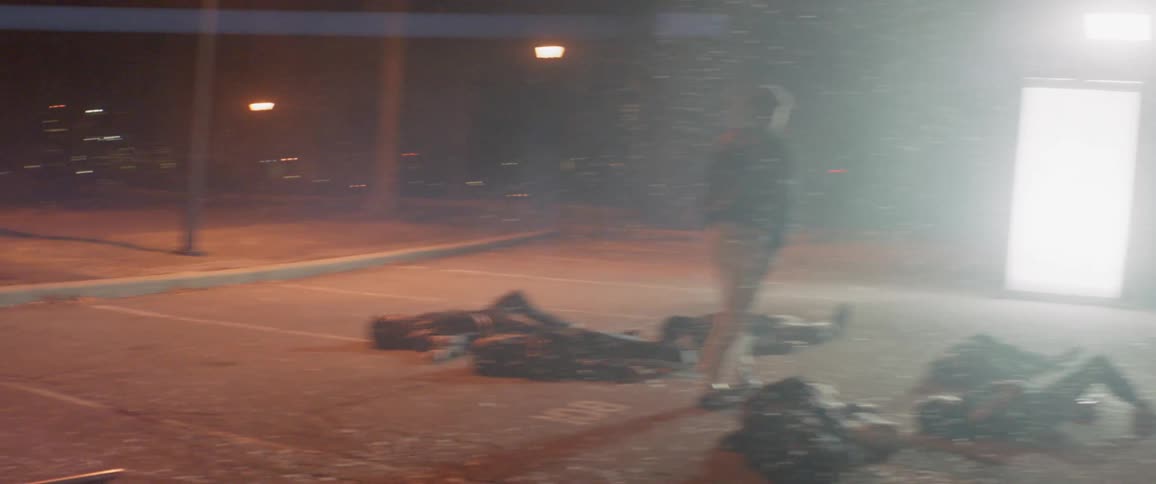A film crew films outside at night