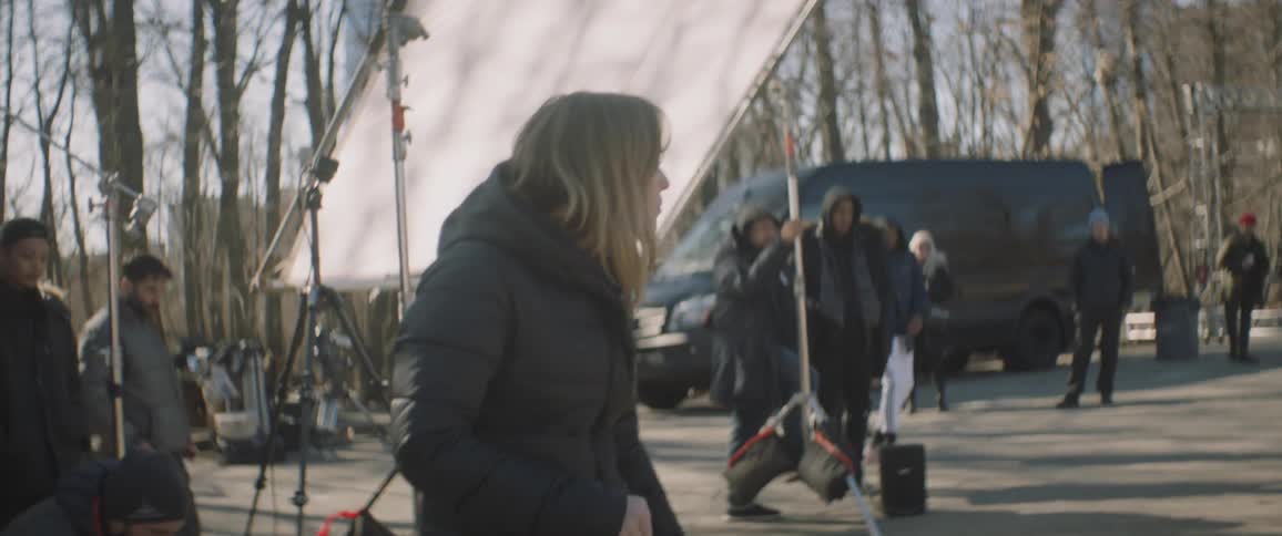 Woman dances in front of a film crew