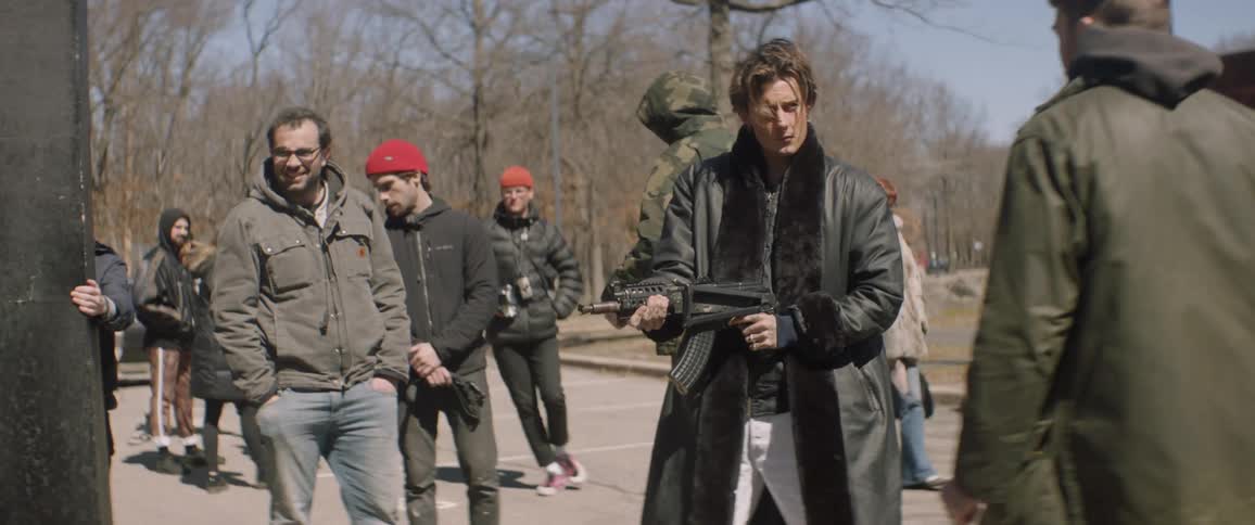 Man assembles a prop gun and pretends to shoot it