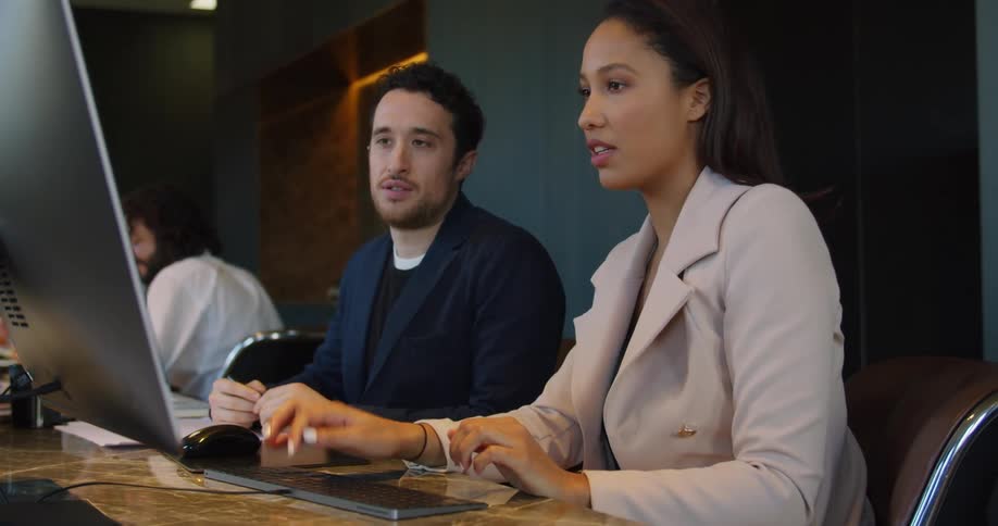Young woman explaining something to her male colleague