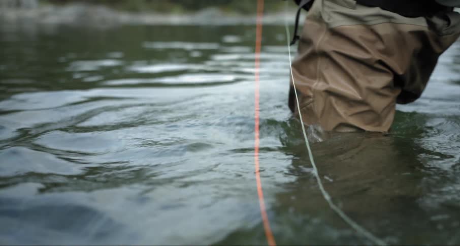 A man fishes in a stream