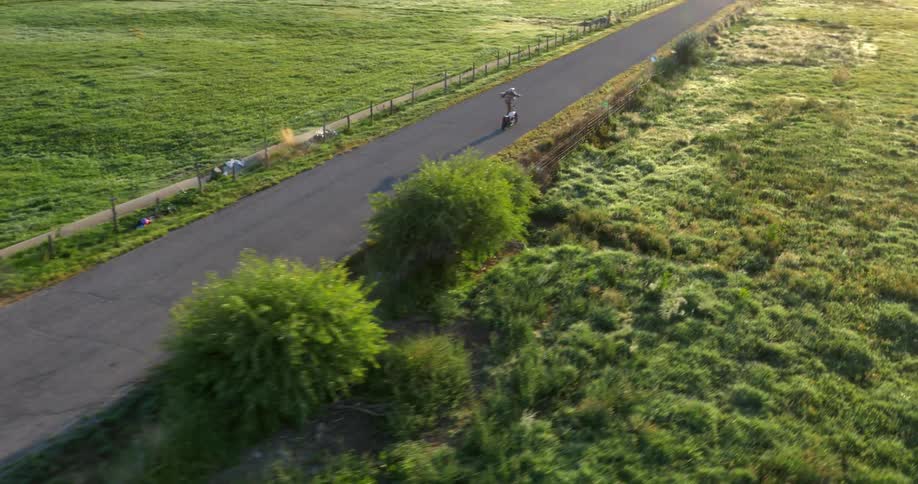A motorcyclist who is performing a stunt crashes off his bike