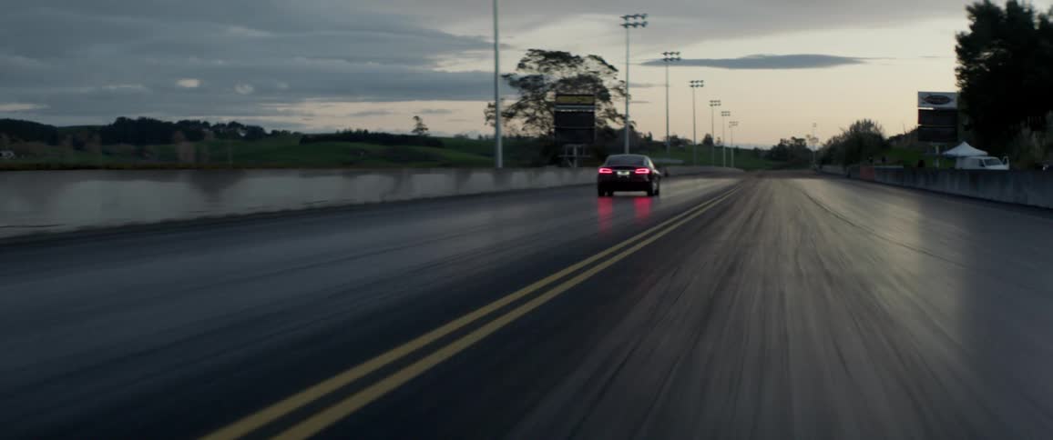 A car drives down a speed track