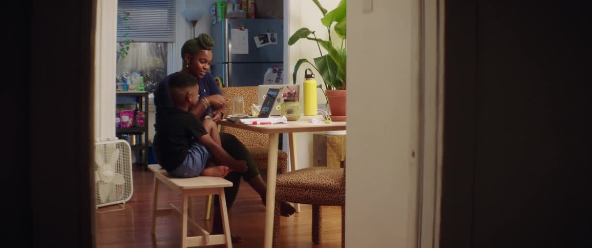 A mother and son look at a tablet together