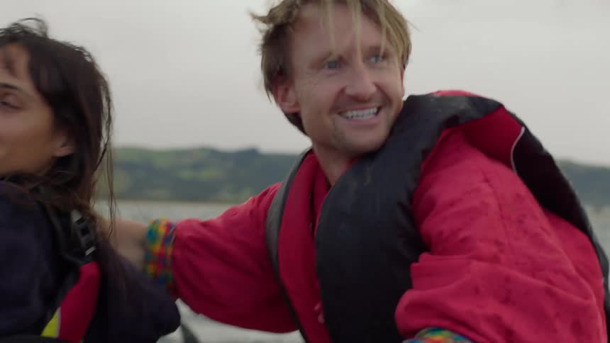 A man puts his arm around his wife while on a boat