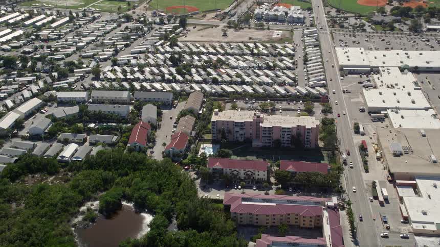 Tilting down from aerial view exploring residential apartments located in the sunny neighborhood of Key West Florida during summer