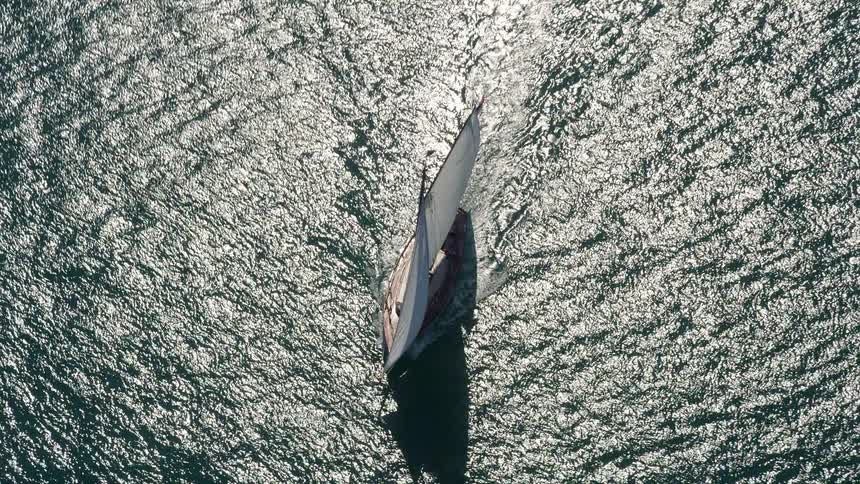 A leisurely sailboat cruise caught from high above with stunning vistas of deep blue waters off Floridas Key West coast during the summer season