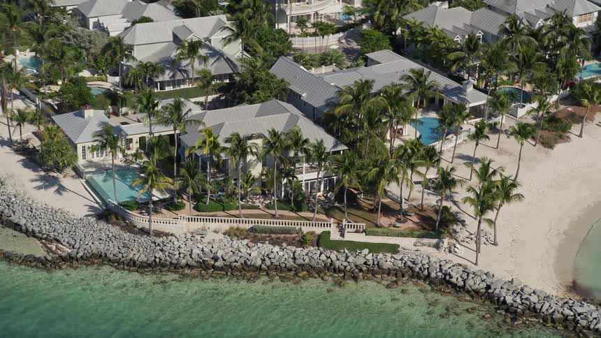 Aerial view of high-end residential homes located on the beachfront of Sunset Key Key West Florida during a sunny day