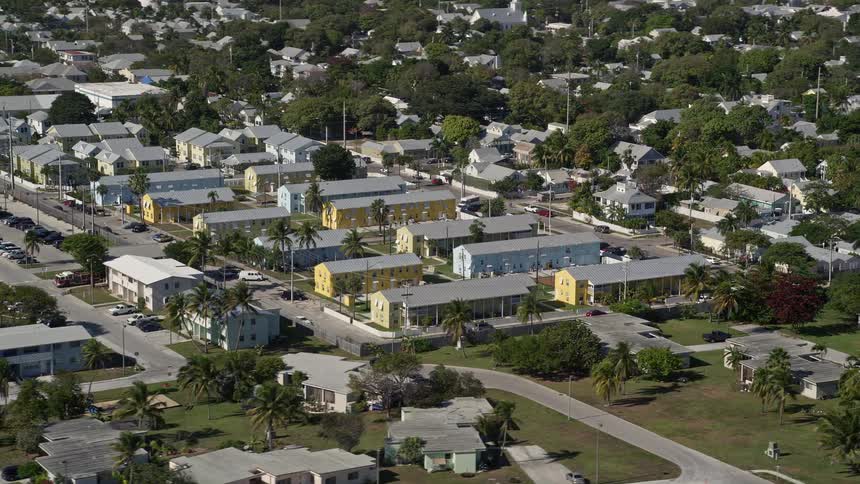 The camera flies over the residential barracks at NAS Key West Truman Annex in Key West Florida providing a stunning aerial view during a sunny day in summer