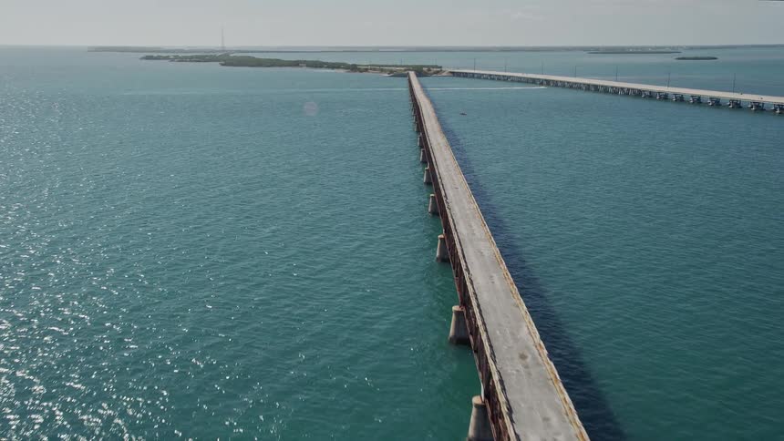 Aerial view of Old Bahai Honda Bridge while flying over it showcasing the beautiful nature area and Atlantic Ocean on Bahai Honda Key in Florida during the daytime