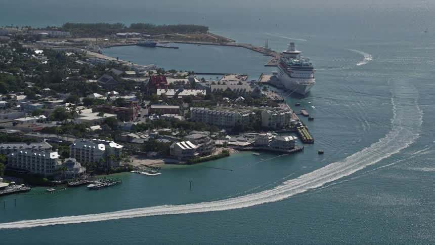 An aerial view of hotels on the shore before approaching the Royal Caribbean ship in Key West Florida during a sunny day with cruise ships in sight