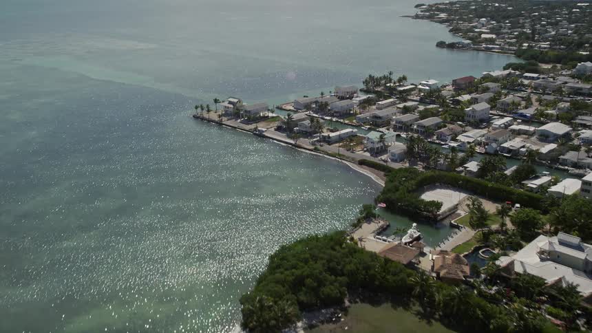 Approaching coastal residences alongside the Atlantic Ocean in Marathon Florida on a sunny day