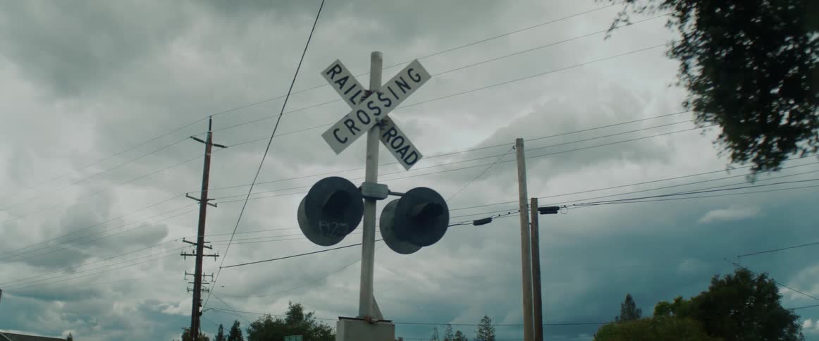 A road sign is displayed in a rural city