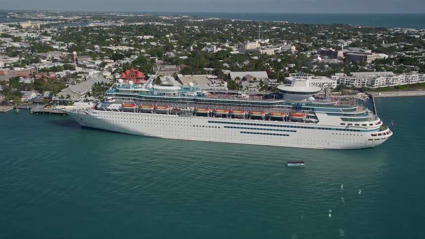 A breathtaking 5K aerial orbit of a Royal Caribbean Cruise Ship docked in Key West Florida offering views of cruise ship luxury and seaside entertainment