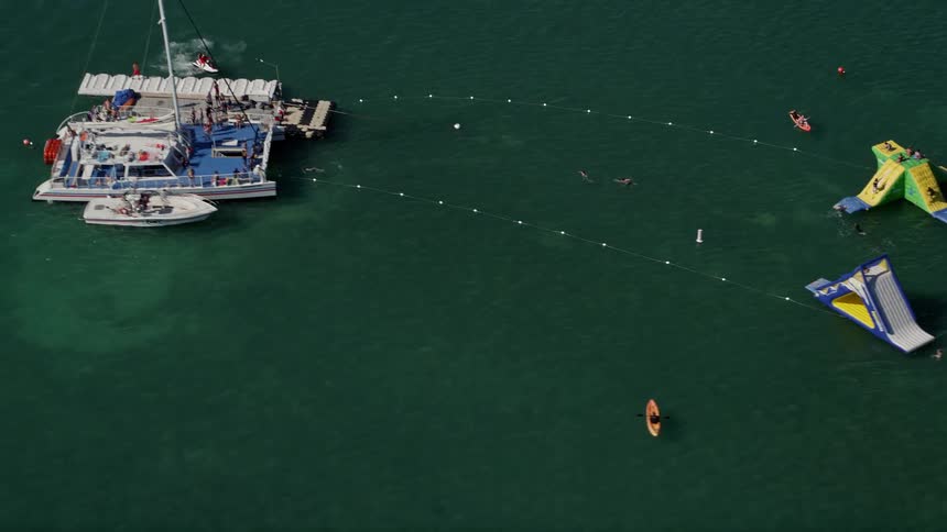 Aerial footage of swimmers and floats off the shores of Key West Florida during summer