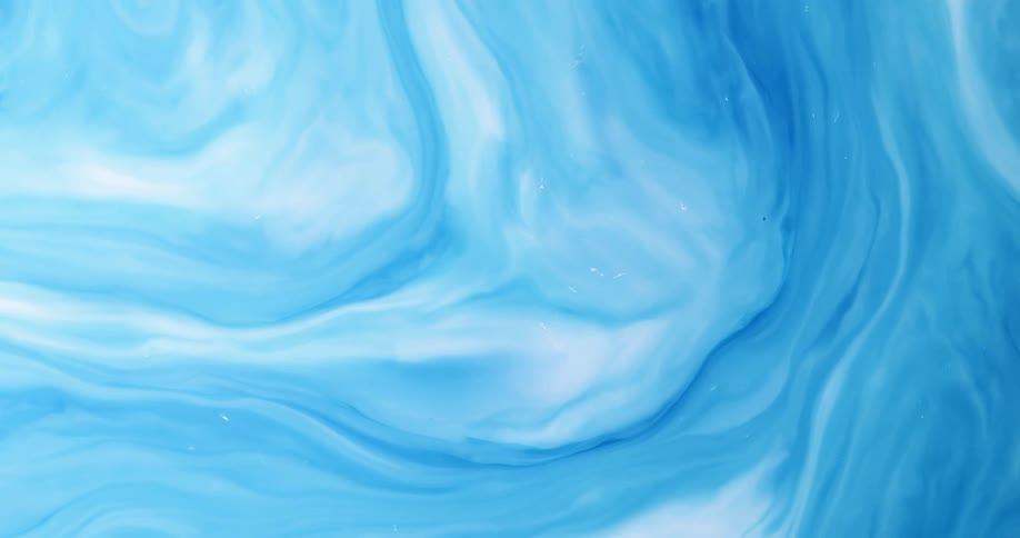 A liquid of several shades of blue swirls and flows momentarily before slowing down and stopping