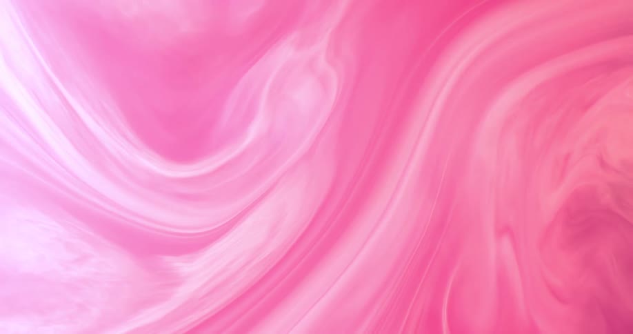 Pink and white liquids swirl together to create a pattern