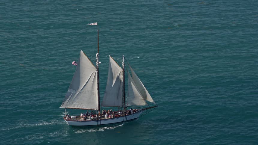 Aerial footage of a sailboat cruising near Key West Florida on a sunny summer day