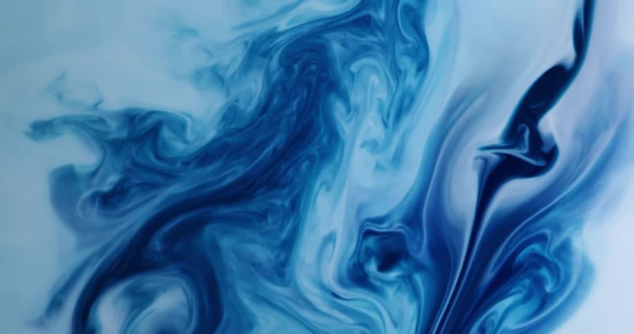 Dark blue and white paint swirl together to create a pattern