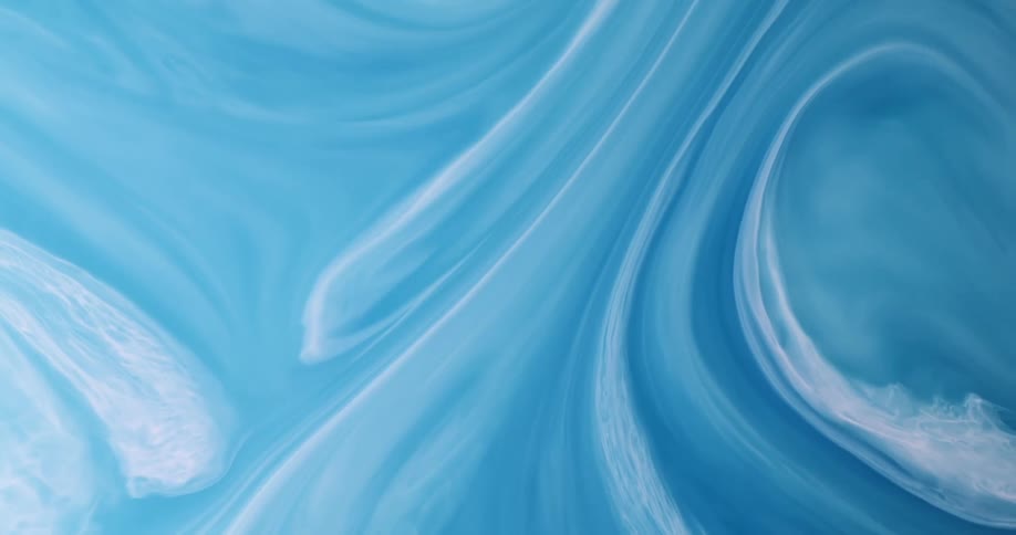 Viscous blue liquids swirl together to make a beautiful surreal scene