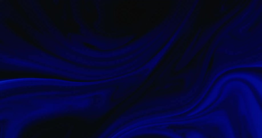 A blue liquid swirls and mixes with a black liquid in this surreal setting