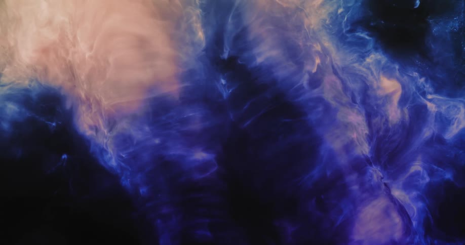 In the darkness a colorful cloud swirls and blends around