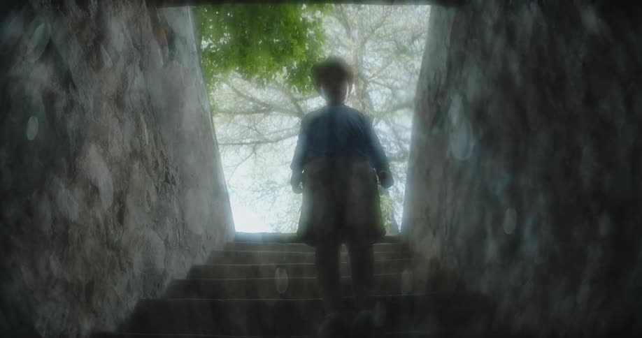 Rippling reflection shows child standing on enclosed stairs with opening behind them